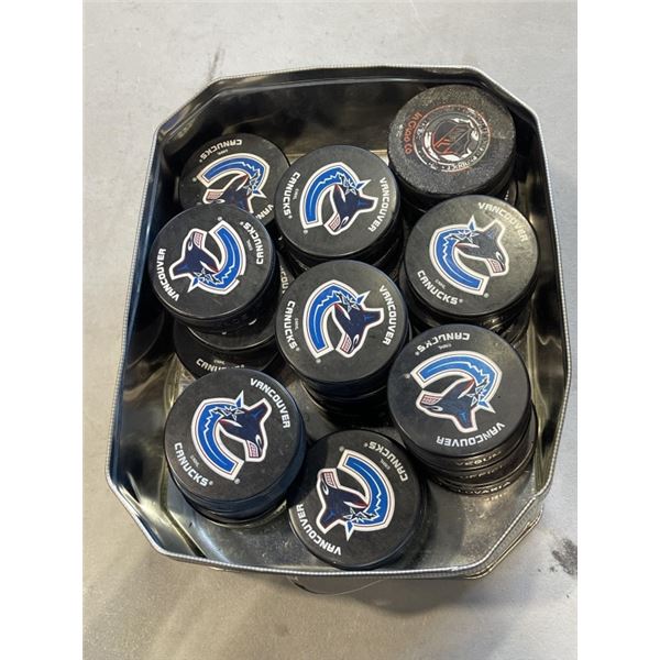 TIN OF 26 VANCOUVER CANUCKS BRANDED HOCKEY PUCKS
