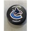 Image 2 : TIN OF 26 VANCOUVER CANUCKS BRANDED HOCKEY PUCKS