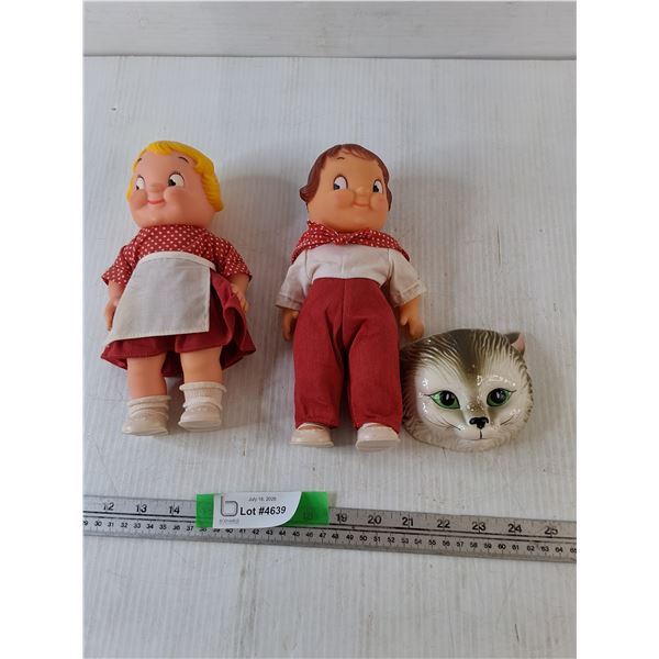 (2) Plastic Dolls, (1) Porcelain Cat Face Wall Decoration