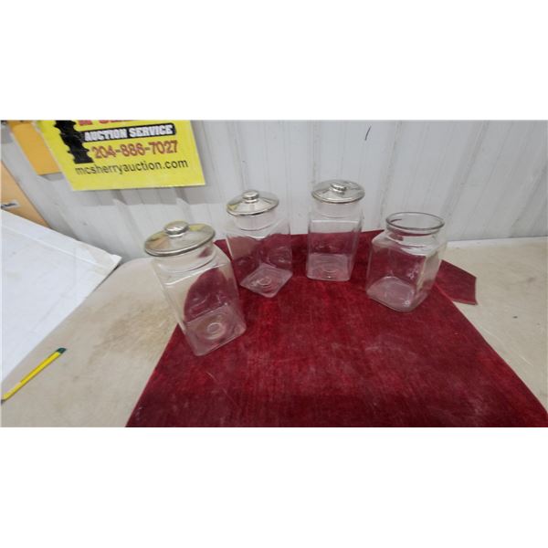 Set of Four Clear Glass Square-Base Store Canisters with Metal Lids and Finial Knobs