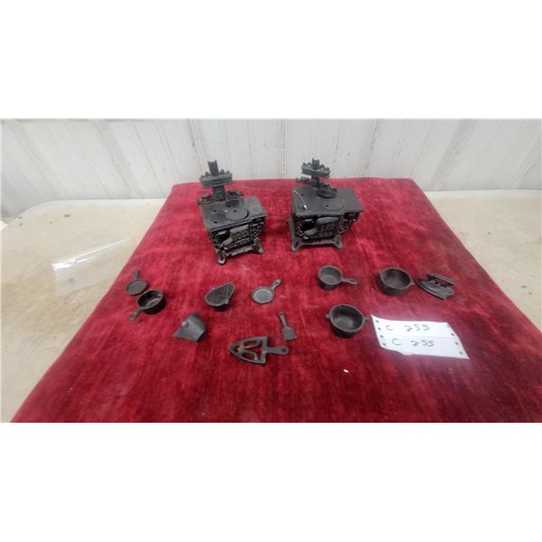 Two Miniature Cast Iron Toy Stoves with Pots, Pans, Utensils, and More