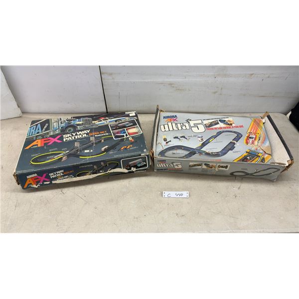 Aurora AFX Skyway Patrol HO Scale Road Set and Ultra 5 Grand Challenge Slotless Race Set.