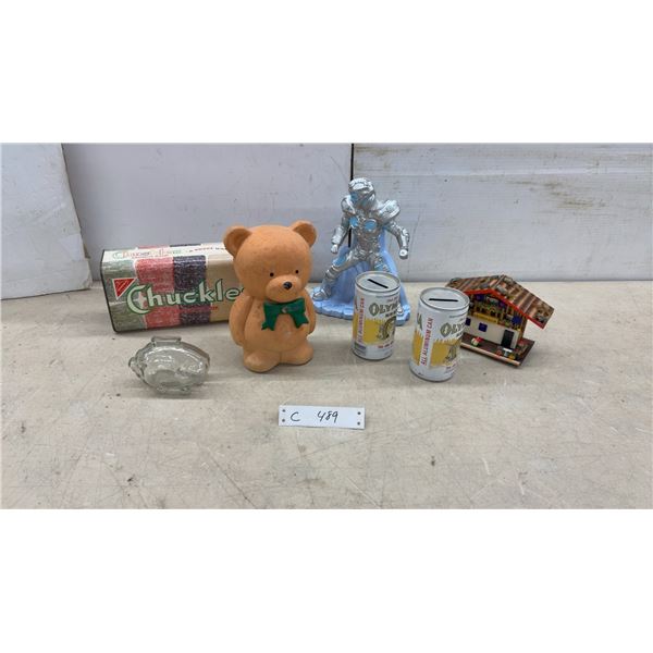 Collection of Coin Banks Including Olympia Beer Cans, Chuckles Savings Bank, and More