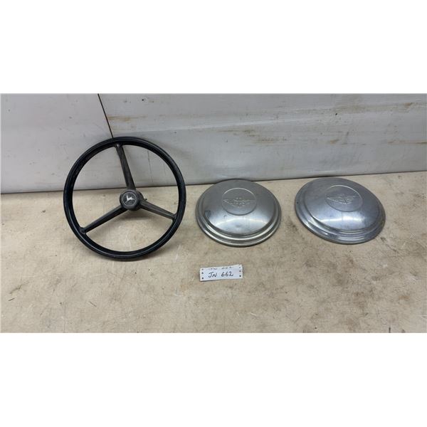 John Deere Tractor Steering Wheel and Two Vintage Pontiac Winged Goddess Hubcaps