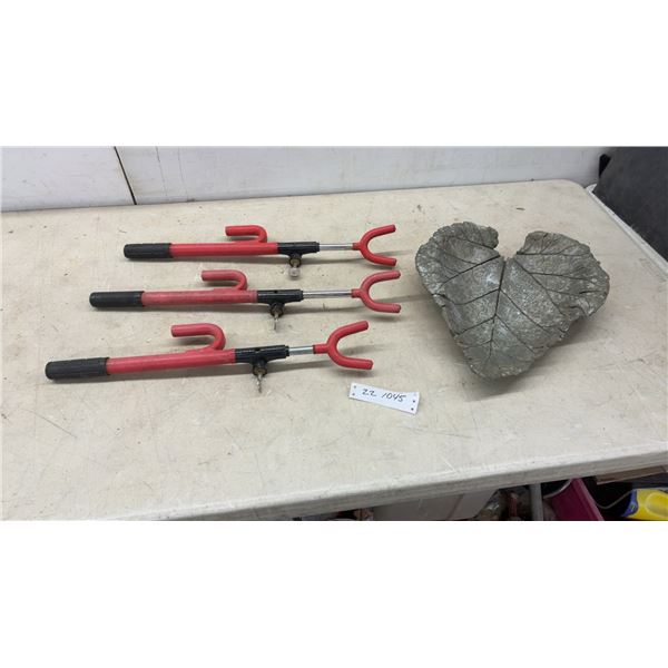 Three Red Steering Wheel Locks with Keys and Decorative Leaf-Shaped Concrete Garden Stone