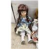 Image 2 : Set of Four Collectible Porcelain Dolls with Lace-Trimmed Dresses and Braided Hair