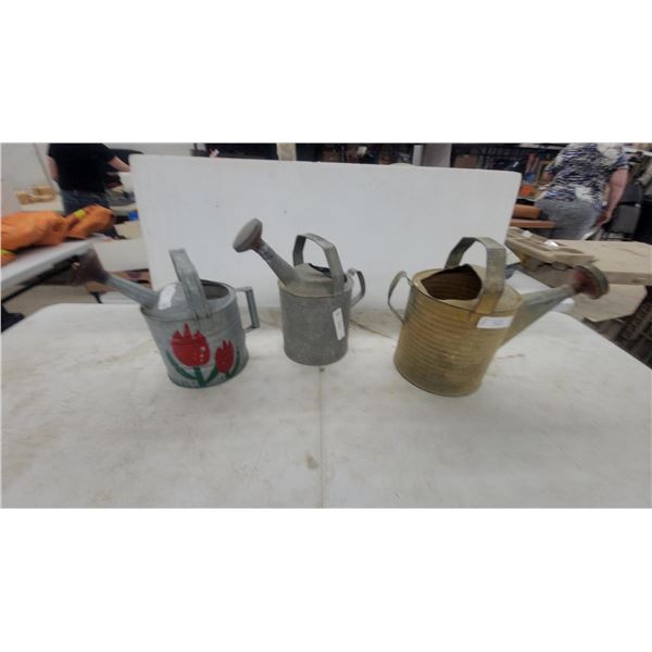 Three Vintage Galvanized Metal Watering Cans Including Ribbed Brass-Tone and Tulip Painted