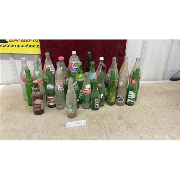 Vintage Glass Soda Bottles Including Coca-Cola, Pepsi, Sprite, 7UP, Mountain Dew, and More