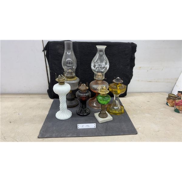 Collection of 7 Oil Lamps: 2 Tall Clear Glass, 1 White Milk Glass, 1 Red, 1 Black, 1 Green