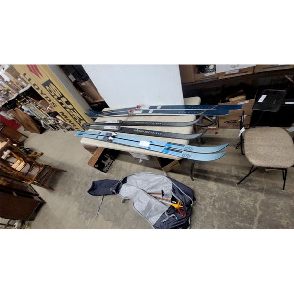 Three Pairs of Cross-Country Skis: Elan FW, Dynatour Silver Star, and Explorer with Poles and Bag