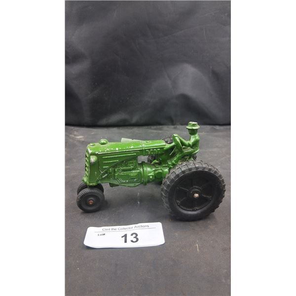 Cast iron toy tractor with driver 5" long