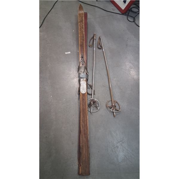 Pair of antique skis with poles