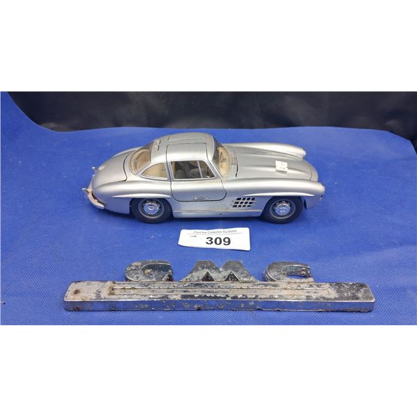 1:18 scale die cast Mercedes Benz and vintage GMC emblem