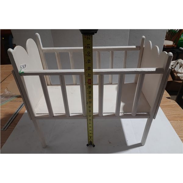 White wooden doll crib.