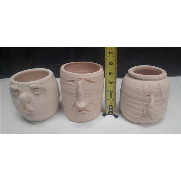 Vintage handmade ceramic face pots.