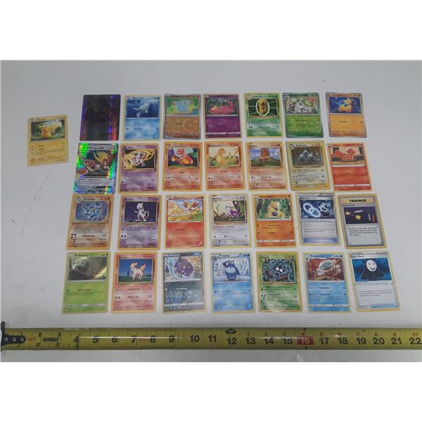 Collection of various vintage Pokémon trading cards featuring characters like Charizard and Pikachu.