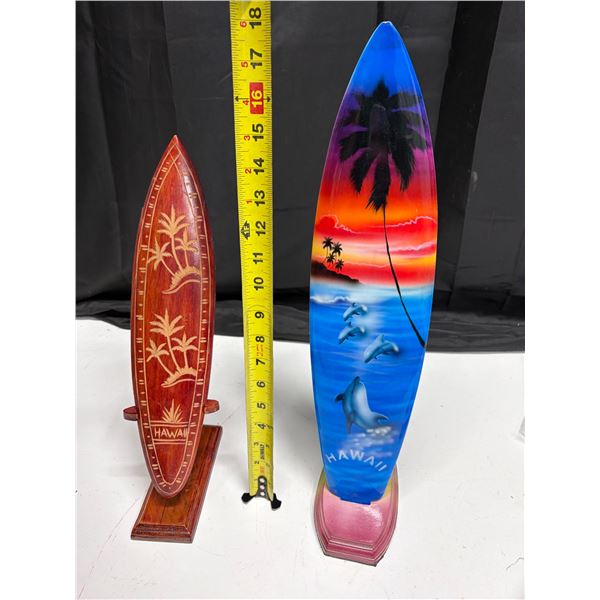 (2) Decorative Hawaiian-themed surfboard souvenir, typically made of carved wood.