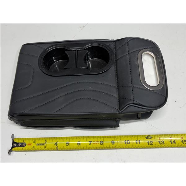 Auto center console armrest pillow features a quilted design and integrated cup holders.