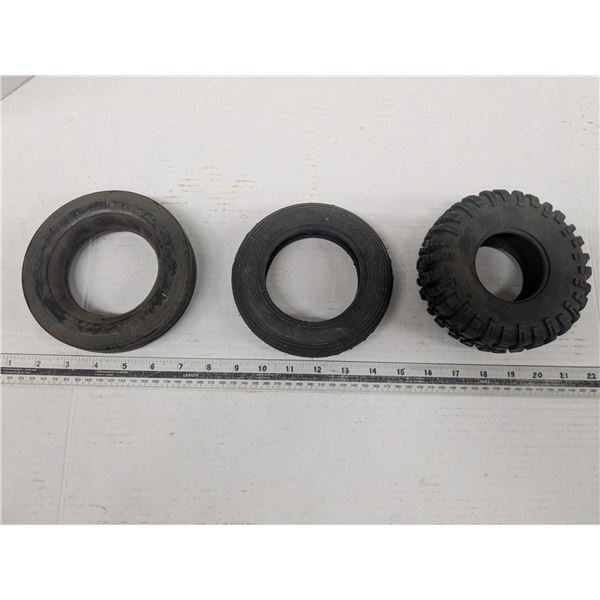 3 small rubber tires, approximately  6" diameter, one solid