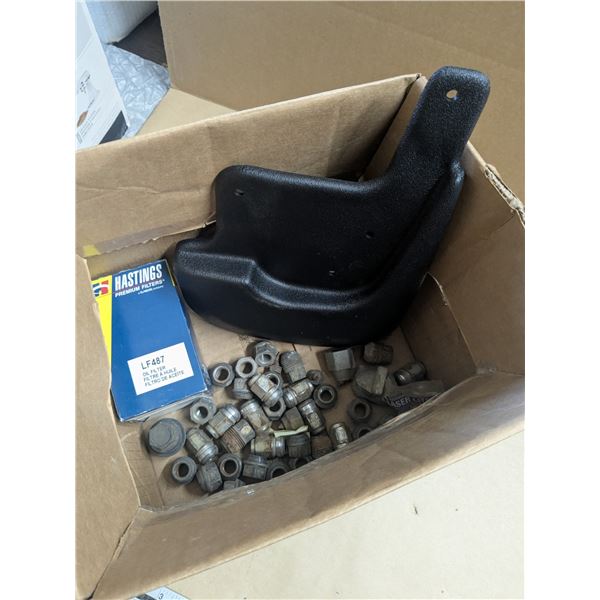 box of vehicle parts, mudflap, oil filter, wheel nuts