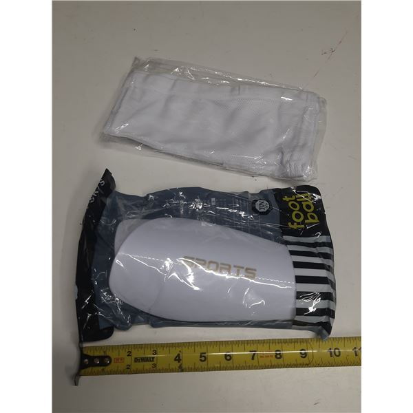 White soccer shin guards feature a hard protective shell and come packaged with sleeves protectors. 