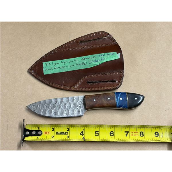 512 Layer High Carban Damacus Steal Knife features a handle crafted from a combination of wood, bras