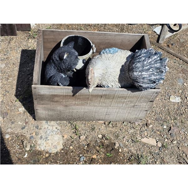 Wooden crate and garden décor statues