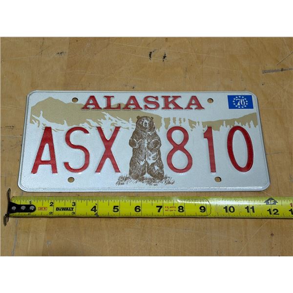 1976 Alaska license plate featuring the iconic Kodiak bear graphic and a specific '76 bicentennial s