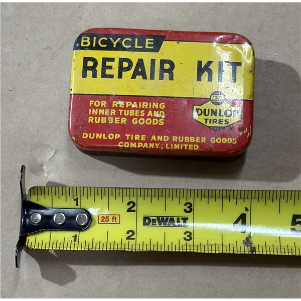 Vintage Dunlop Tires bicycle repair kit in a classic yellow and red metal tin. (Empty)