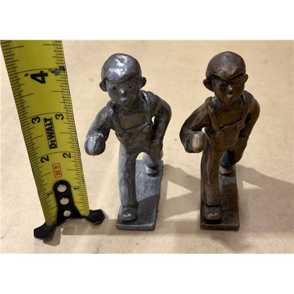 Vintage cast iron "Sandy" boy shoveler figurines, often marketed as bookends or doorstops.