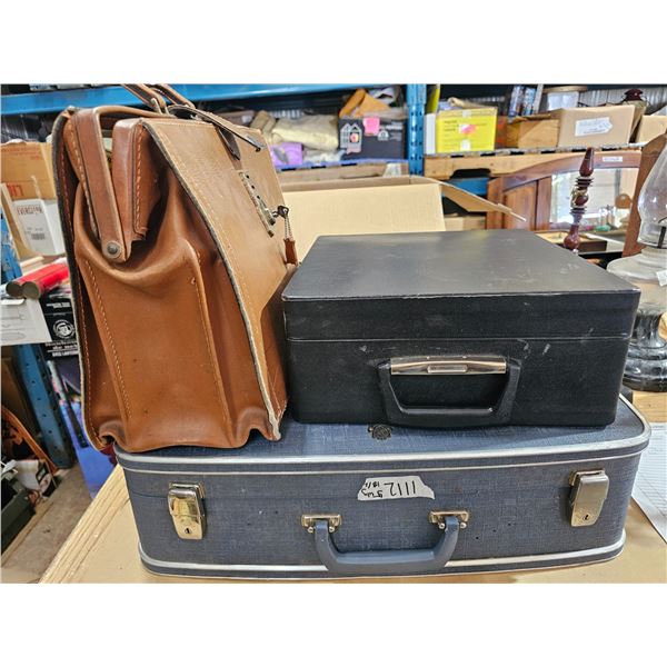 2 vintage suitcases and black chest