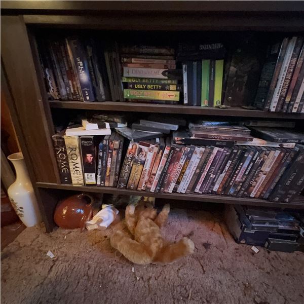 DVD Lot and VHS Tapes on Wooden Shelf