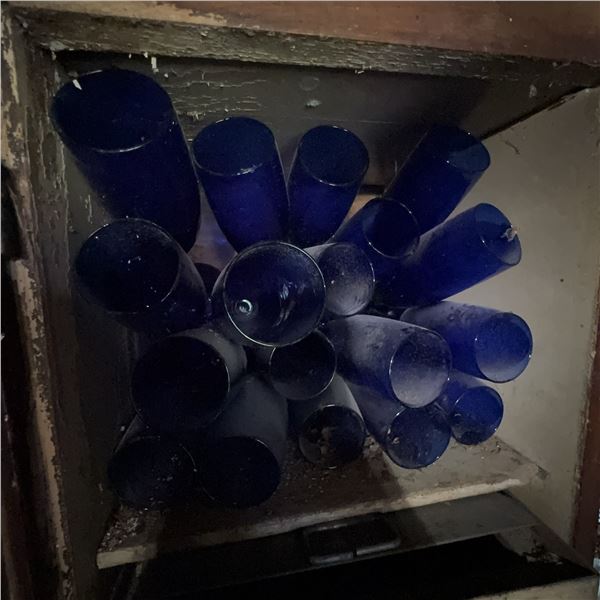 Vintage Blue Glass Bottles in Old Wooden Cabinet