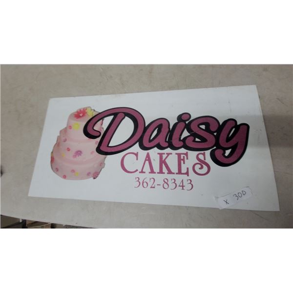 Daisy Cakes Metal Advertising Sign with Three-Tiered Cake Graphic 14”×22”