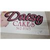 Image 4 : Daisy Cakes Metal Advertising Sign with Three-Tiered Cake Graphic 14”×22”