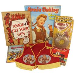 Annie Oakley NOS canteen sealed on display card, vest, books, coloring book & theater book, c.1950's