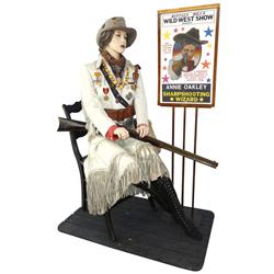 Annie Oakley mannequin, seated, contemporary, old buckskin clothes, medals, bag & rifle, comes w/Buf