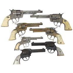Gene Autry cap guns (7), made by Leslie-Henry, Halco, etc., 2 are cast iron w/pearlized grips (grips