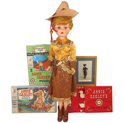 Annie Oakley items, framed trade card, Shooting Gallery Soap Set, puzzle sets & vinyl doll, some rou