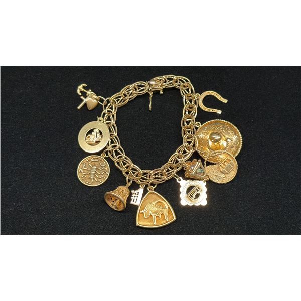 APPROX 10K CHARM BRACELET WITH ELEVEN APPROX 10K+ CHARMS (35.1G)