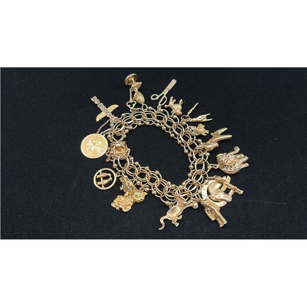 APPROX 14K CHARM BRACELET WITH MULTIPLE 10K+ CHARMS (69.2G)
