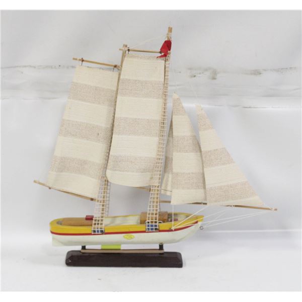VINTAGE YELLOW-HULLED TRADITIONAL SAILING BOAT