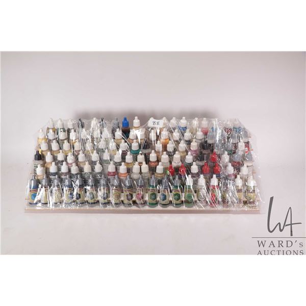 Seven tier paint holder with a large selection of dropper bottle style acrylic paints, mostly Valleg