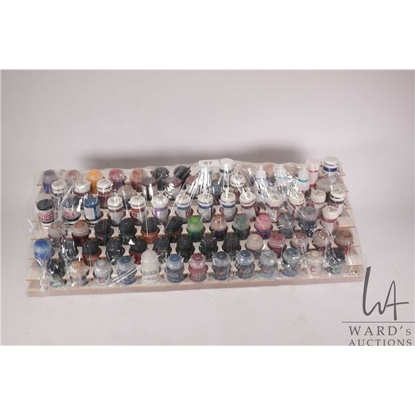 Seven tier paint holder with a large selection of acrylic miniature paints, mostly Citadel and Found