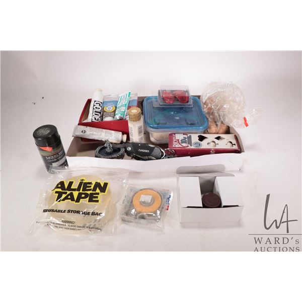 Selection of hobby supplies incuding artist tube style acrylic paint, masking tape, Tamiya color acr