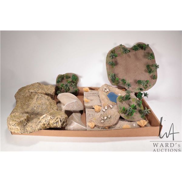 Large selection of tabletop gaming terrain including small forests, rubber rock formations, sandy te