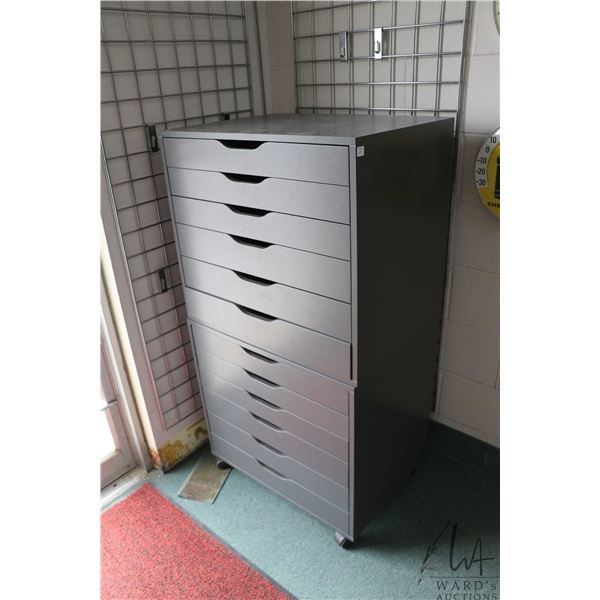 Two Ikea brand "Alex" six drawer storage cabinets, grey in colour, one of castors