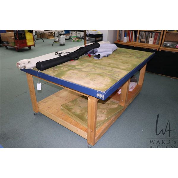 Handmade wooden wargaming table with undershelf, on castors, fitted with WWII trench terrain, 31" H 