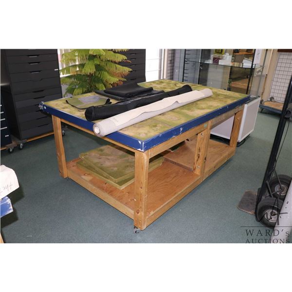 Handmade wooden wargaming table with undershelf, on castors, fitted with WWII trench terrain, 31" H 