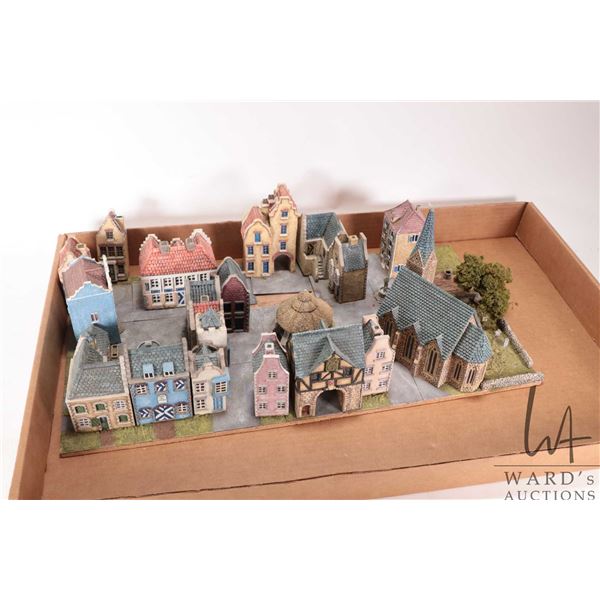 MIniature European diorama featuring two story timber framed houses and thatched roofed buildings as